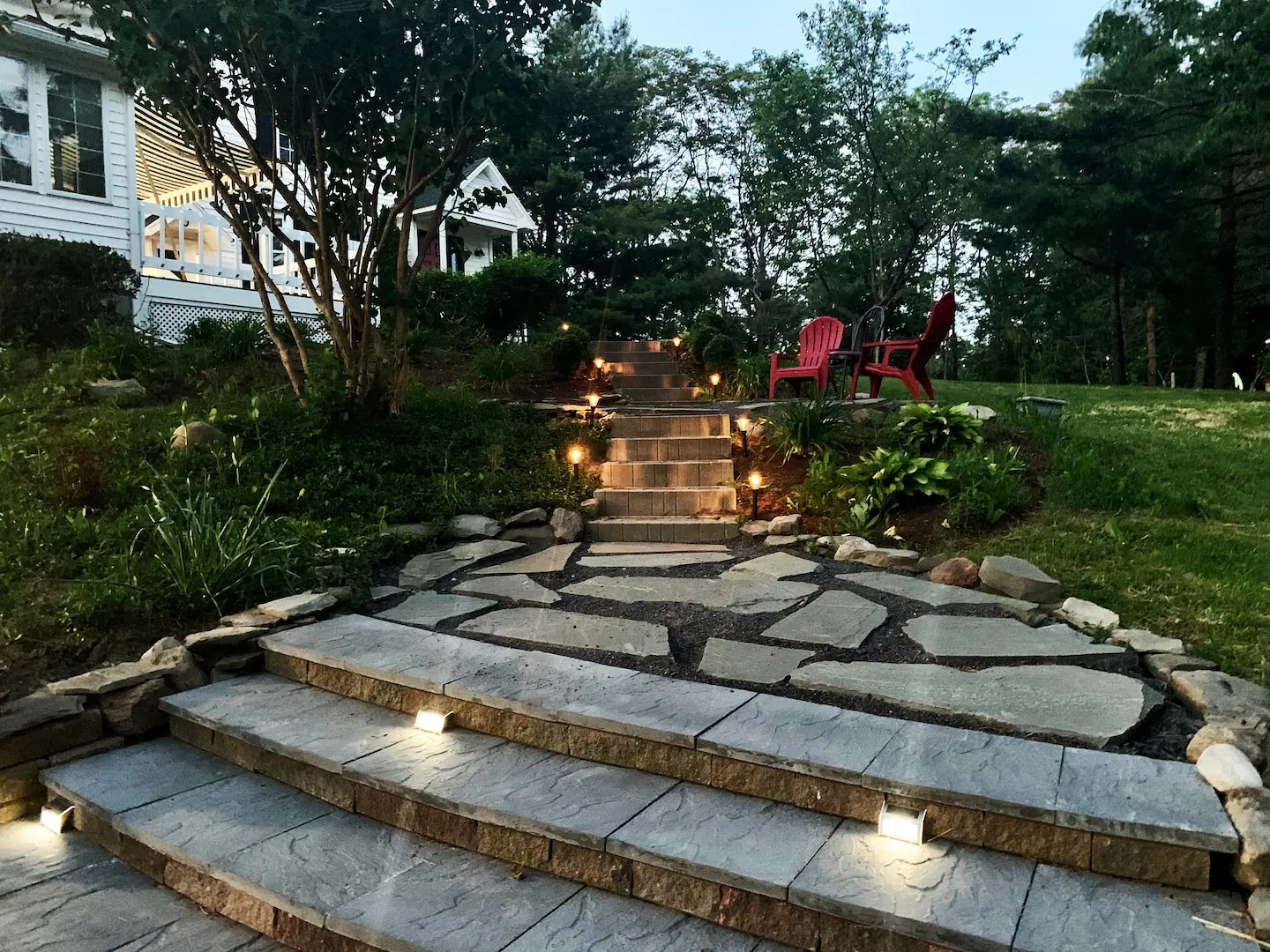 Stone patio steps with flower gardens and outdoor lights