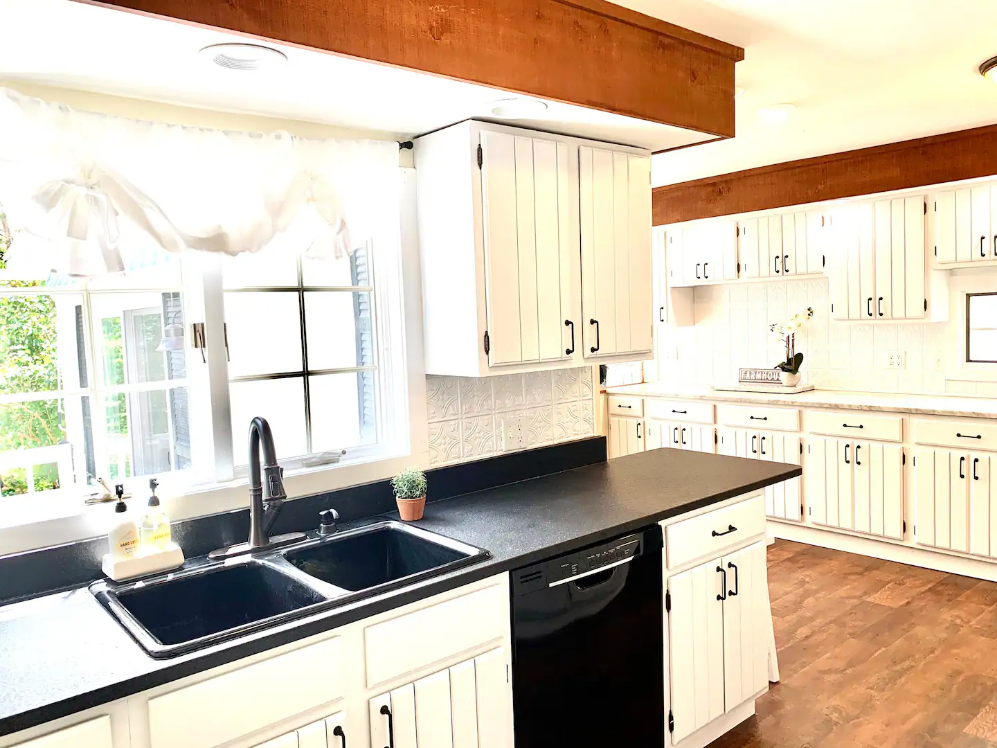 White kitchen with a farmhouse sink and sunlit counters