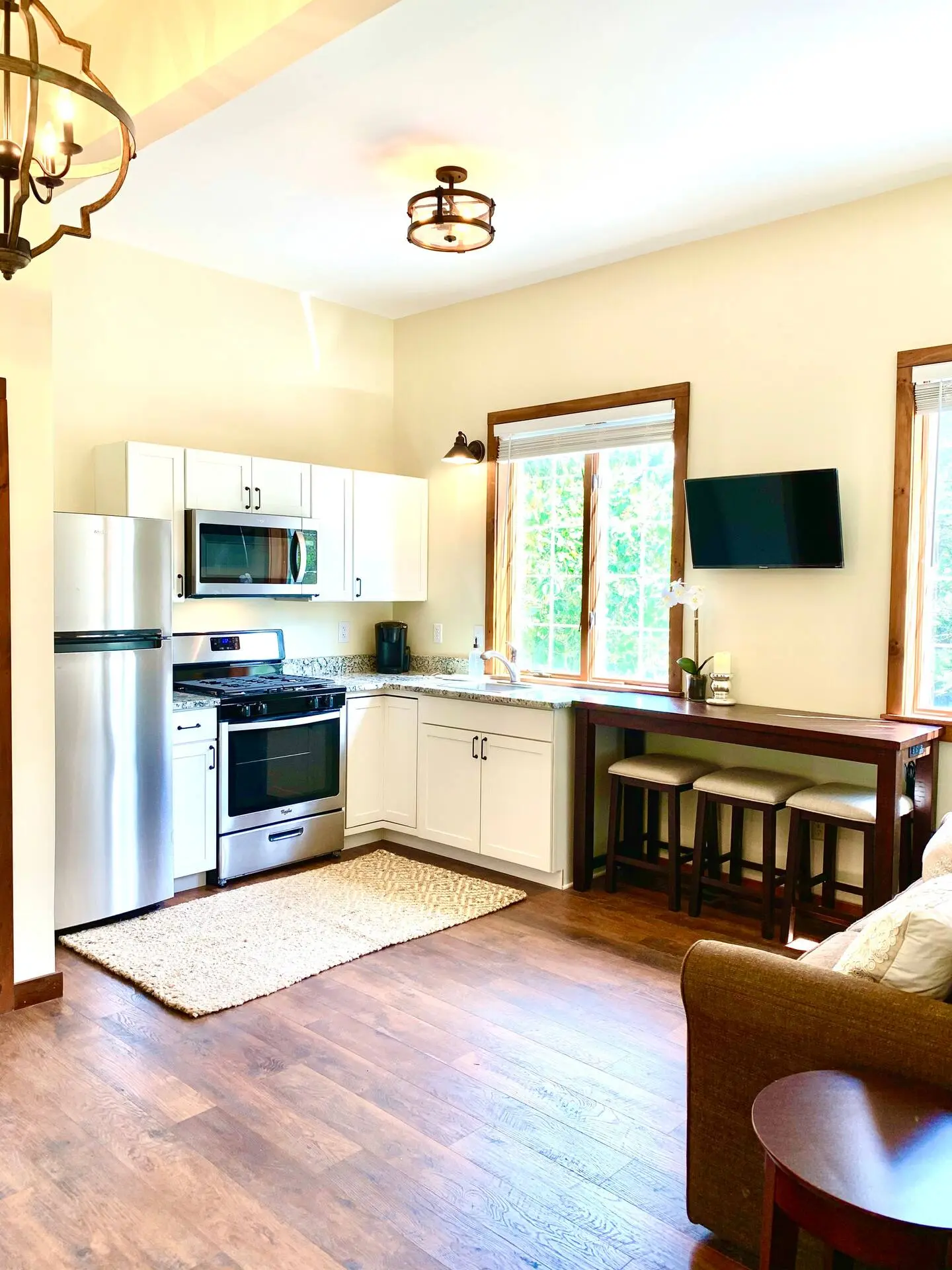 Compact kitchen with wood floors and black appliances